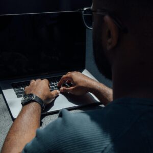 man using laptop computer on desk
